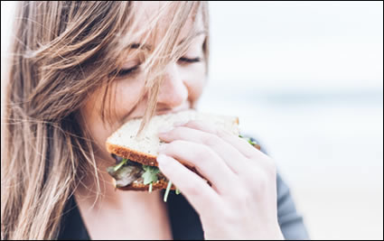 Woman Eating a Sandwich